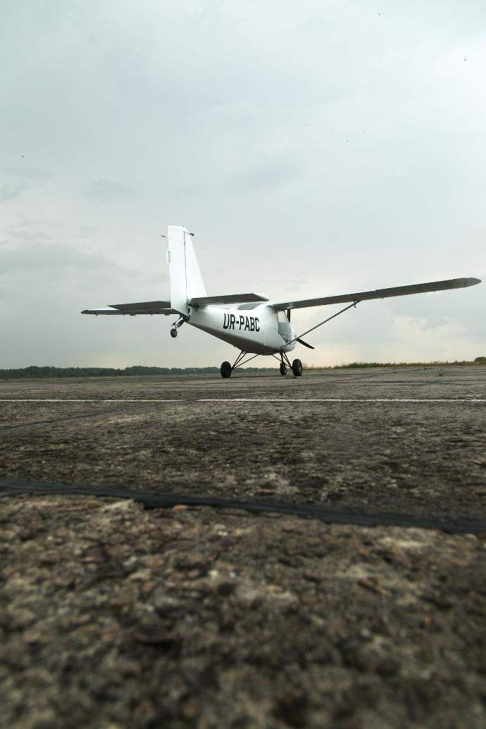 a small airplane sitting on top of an airport runway